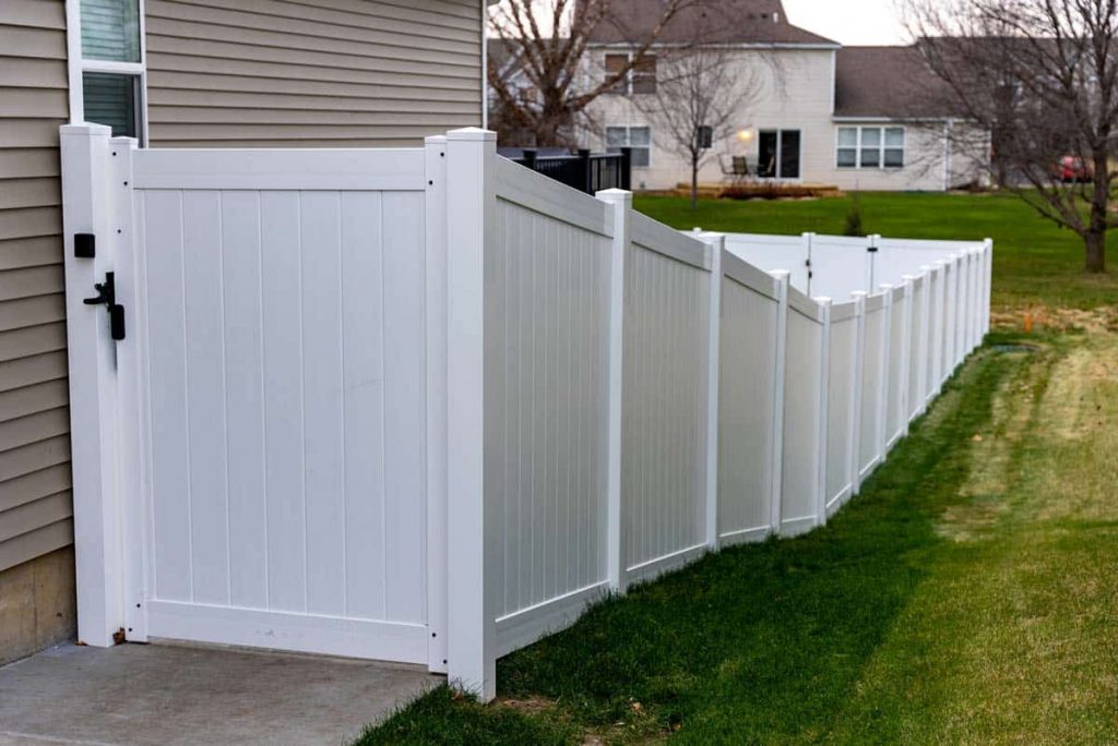 corner of white privacy fence built on a slope Northland Fence of Apple Valley